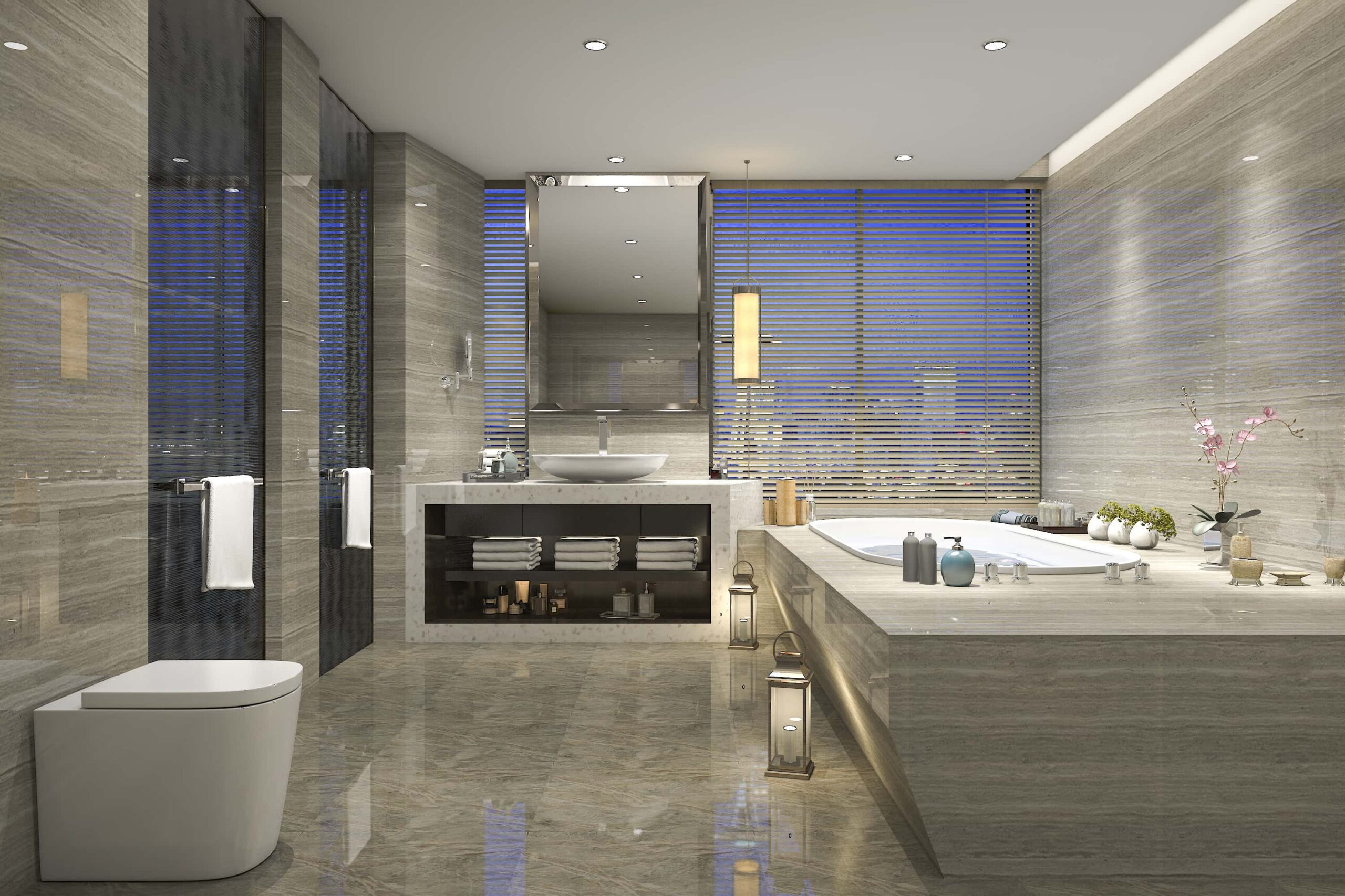 shutterstock_674986813 Luxurious modern bathroom with marble surfaces, a freestanding tub, sink, large mirror, and decorative elements like lanterns and plants, overlooking a window with blinds.